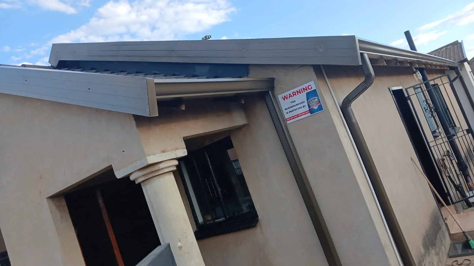 Fascia boards and gutters installed along the eaves of a home